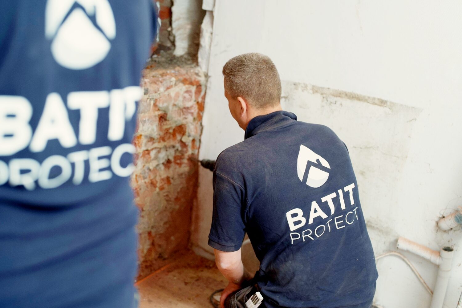 Techniciens HUMY réalisant un traitement humidité dans les murs